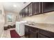 Laundry room with washer, dryer, and upper cabinets at 472 W Dragon Tree Ave, Queen Creek, AZ 85140