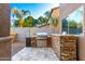 Outdoor kitchen with built-in grill and stone counter at 472 W Dragon Tree Ave, Queen Creek, AZ 85140