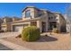 Two-story house with a three-car garage and manicured landscaping at 4844 E Morning Vista Ln, Cave Creek, AZ 85331