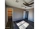 Bright bedroom featuring wood-look floors and ceiling fan at 5001 W Lamar Rd, Glendale, AZ 85301