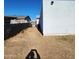 Side yard with dirt and a privacy fence at 5001 W Lamar Rd, Glendale, AZ 85301