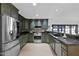 Spacious kitchen featuring dark green cabinetry, granite countertops, and stainless steel appliances at 5301 N 25Th Pl, Phoenix, AZ 85016