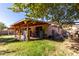 Backyard with covered patio, storage, and grassy area at 8717 W Wilshire Dr, Phoenix, AZ 85037