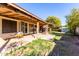Spacious backyard with covered patio and grassy area at 8717 W Wilshire Dr, Phoenix, AZ 85037