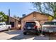House exterior showcasing a two-car garage and landscaping at 8717 W Wilshire Dr, Phoenix, AZ 85037