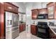Bright kitchen with stainless steel appliances and wood cabinets at 8717 W Wilshire Dr, Phoenix, AZ 85037