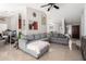 Open living room with grey sectional sofa and view to kitchen at 8717 W Wilshire Dr, Phoenix, AZ 85037