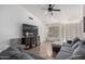 Spacious living room featuring a sectional sofa and large TV at 8717 W Wilshire Dr, Phoenix, AZ 85037