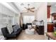 Sunroom with black couch and round ottoman at 8717 W Wilshire Dr, Phoenix, AZ 85037