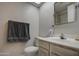 Clean bathroom with sink, toilet, and a large mirror at 8803 N 105Th Ln, Peoria, AZ 85345