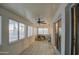 Sunroom with tiled floor, ceiling fan, and window blinds at 8803 N 105Th Ln, Peoria, AZ 85345