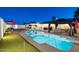 Inviting backyard oasis featuring a sparkling pool, gazebo, and putting green at 8856 E Altadena Ave, Scottsdale, AZ 85260