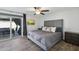 Spacious bedroom with king-size bed,sliding door to patio, and wood-look floors at 8856 E Altadena Ave, Scottsdale, AZ 85260
