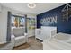 Charming Bedroom with crib, accent wall, and recliner at 8856 E Altadena Ave, Scottsdale, AZ 85260