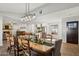 Open dining area with a large wooden table and view of the kitchen at 8856 E Altadena Ave, Scottsdale, AZ 85260