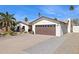 Two-car garage with a paved driveway and mature palm trees at 8856 E Altadena Ave, Scottsdale, AZ 85260