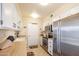 Modern kitchen featuring stainless steel appliances and light wood cabinets at 10254 W Palmeras Dr, Sun City, AZ 85373