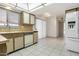 Kitchen with wood cabinets, tile floor, and appliances at 12435 W Galaxy Dr, Sun City West, AZ 85375