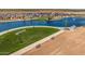 Aerial view of a community park with pond and parking at 1304 W Golden Ore Pass, Apache Junction, AZ 85120