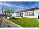 Spacious backyard with artificial turf, a pergola, and patio at 1304 W Golden Ore Pass, Apache Junction, AZ 85120