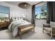 Bright bedroom with a wooden bench and large window at 1304 W Golden Ore Pass, Apache Junction, AZ 85120