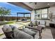 Large Gathering room with sectional sofa, accent chair, and wood wall features at 1304 W Golden Ore Pass, Apache Junction, AZ 85120