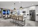 Modern kitchen with white cabinets, island with seating, and pendant lighting at 1304 W Golden Ore Pass, Apache Junction, AZ 85120