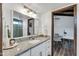 Bathroom with granite vanity, large mirror, and view of bedroom at 1401 W Ocotillo Rd, Phoenix, AZ 85013