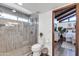 Bathroom with walk-in shower, toilet and view to bedroom at 1401 W Ocotillo Rd, Phoenix, AZ 85013