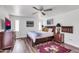 Bedroom with wood furniture, large TV, and ceiling fan at 1401 W Ocotillo Rd, Phoenix, AZ 85013