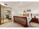Guest bedroom with mirrored closet and wood floors at 1401 W Ocotillo Rd, Phoenix, AZ 85013