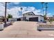 Two-story home with black garage door and driveway at 1401 W Ocotillo Rd, Phoenix, AZ 85013