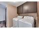 Laundry room with washer, dryer, and overhead cabinets at 1401 W Ocotillo Rd, Phoenix, AZ 85013