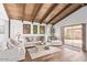 Living room with vaulted wood ceilings, sliding doors, and comfy seating at 1401 W Ocotillo Rd, Phoenix, AZ 85013