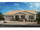 Single-story home with a two-car garage and stone accents at 1426 E Jaycie Dr, Casa Grande, AZ 85122