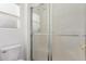 Cozy bathroom featuring a glass shower enclosure, white tile, and a toilet at 14995 W Desert Hills Dr, Surprise, AZ 85379