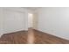 Bedroom featuring wood-look floors and sliding door closet for easy access at 14995 W Desert Hills Dr, Surprise, AZ 85379