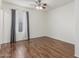 Comfortable bedroom enhanced by wood-look floors and plenty of natural light at 14995 W Desert Hills Dr, Surprise, AZ 85379