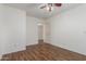 Bedroom with wood-look floors and an open doorway, offering a welcoming feel at 14995 W Desert Hills Dr, Surprise, AZ 85379