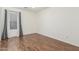 Neutral bedroom with wood-look floors and natural light from the window at 14995 W Desert Hills Dr, Surprise, AZ 85379