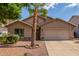 Charming single-story home featuring a two-car garage, desert landscaping and mature palm trees at 14995 W Desert Hills Dr, Surprise, AZ 85379