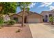 Charming single-story home featuring a two-car garage, desert landscaping and mature palm trees at 14995 W Desert Hills Dr, Surprise, AZ 85379