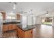 Open-concept kitchen with a kitchen island and stainless steel appliances at 14995 W Desert Hills Dr, Surprise, AZ 85379