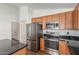 Kitchen area showcasing stainless steel appliances and wood cabinetry at 14995 W Desert Hills Dr, Surprise, AZ 85379