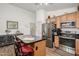 Kitchen island with seating and stainless steel appliances at 14995 W Desert Hills Dr, Surprise, AZ 85379