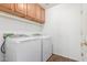 Laundry room featuring washer, dryer, cabinets, and shelving at 14995 W Desert Hills Dr, Surprise, AZ 85379