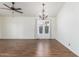 Bright living room with tile floors, a ceiling fan, and a chandelier at 14995 W Desert Hills Dr, Surprise, AZ 85379