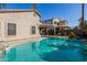 Relaxing kidney-shaped pool with surrounding patio and landscaping at 14995 W Desert Hills Dr, Surprise, AZ 85379