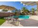 Stunning pool with patio furniture under a pergola at 14995 W Desert Hills Dr, Surprise, AZ 85379