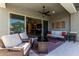 Relaxing back patio with seating area, fire pit, and view of the backyard at 15320 W Baden St, Goodyear, AZ 85338